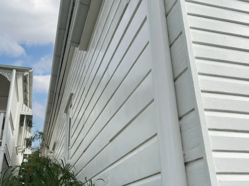 Brisbane weatherboard home after external house washing, clean white cladding